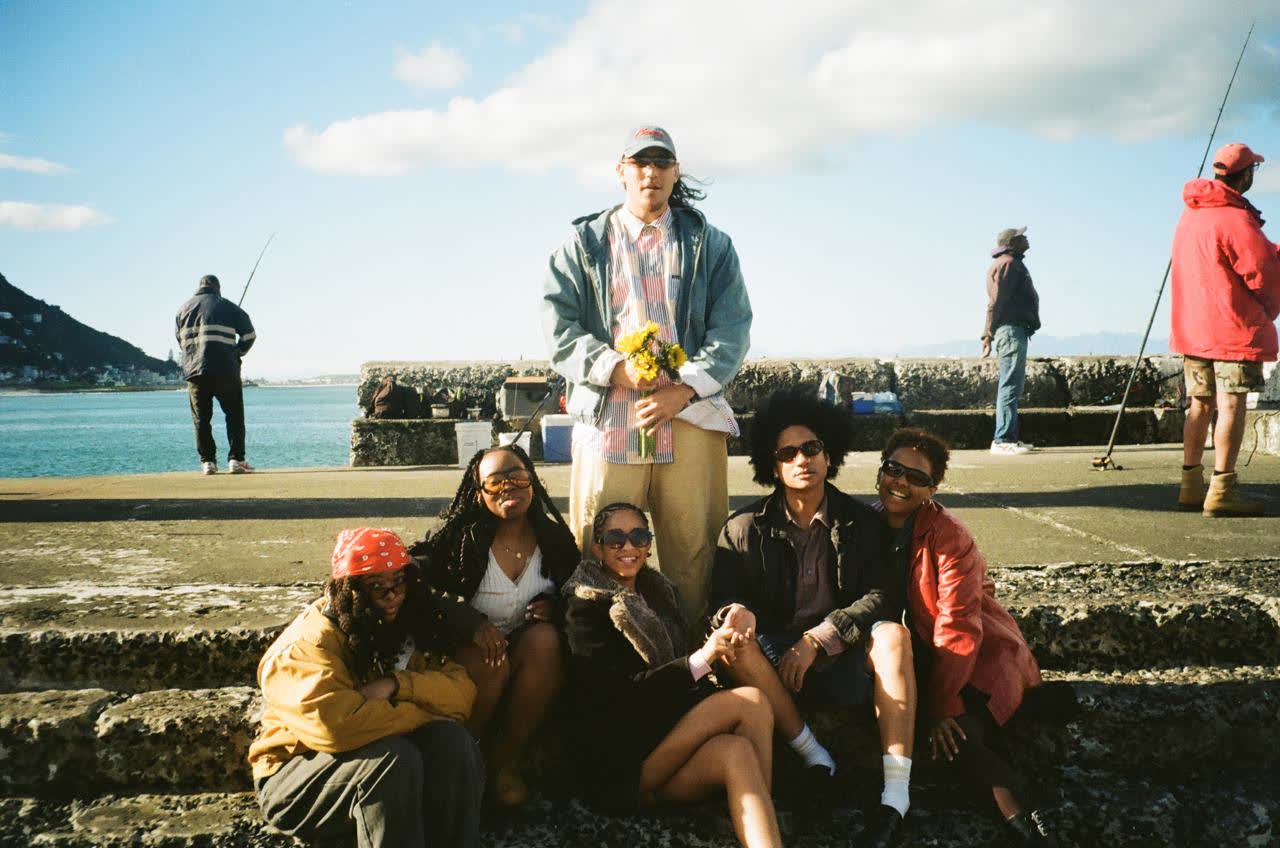Group of friends in hand-picked preloved streetwear on the Cape Town promenade